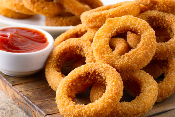 istock Fried onion rings with mozzarella or plain. Delicious onion rings on table 2170298901