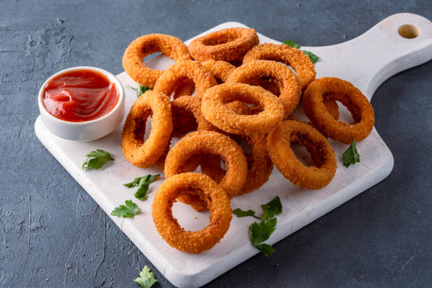 istock Fried onion rings with mozzarella or plain. Delicious onion rings on black background 2170298985