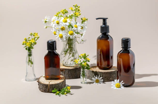 istock cosmetic containers on a wooden podium surrounded by chamomile and hypericum flowers 2170299495