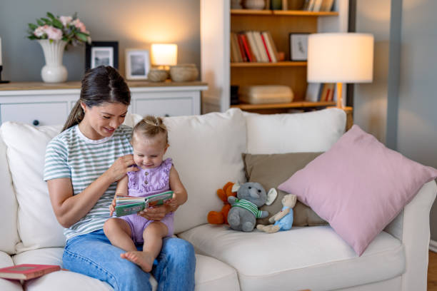 istock Mother excites her child while reading on the sofa. 2170299870
