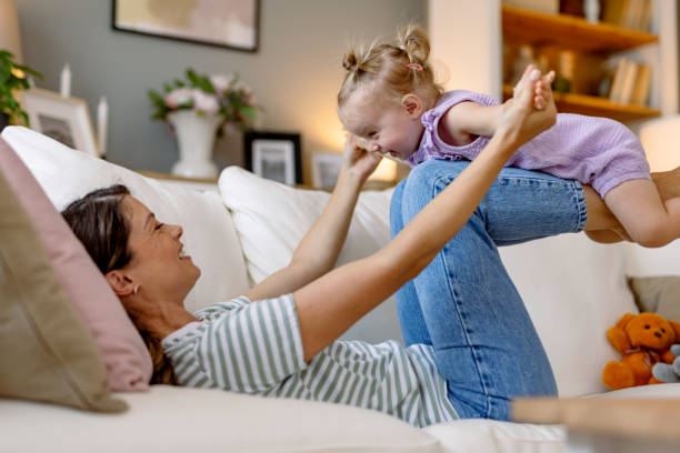 istock Mother and daughter bonding while playing on the sofa. 2170299927
