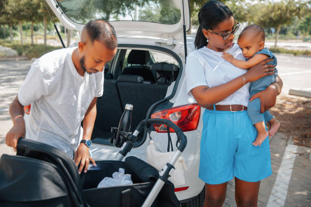 istock Parents preparing baby stroller near car 2170300051