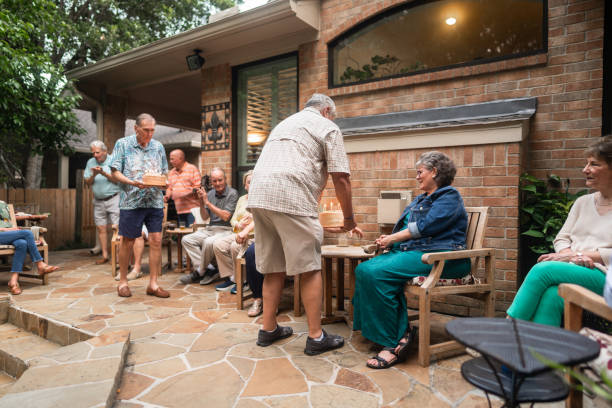 istock Group of seniors having an outdoors birthday party 2170300400