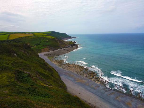 istock Coastal landscape with green hills and blue ocean in Devon, England. 2170301379
