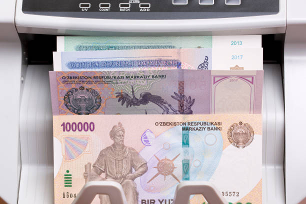 istock Uzbekistani sum in the counting machine 2170302368