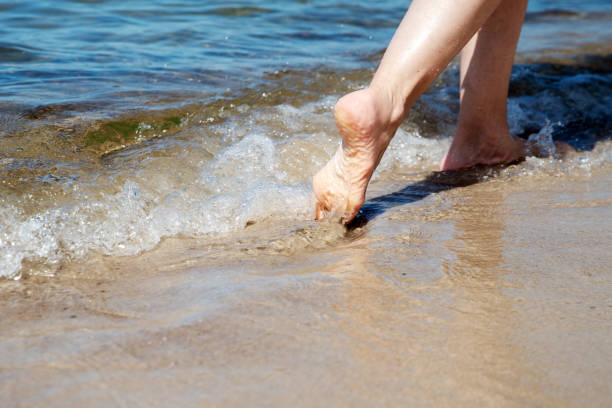Sea beach travel - woman walking on sand beach with blurred areas and copy space