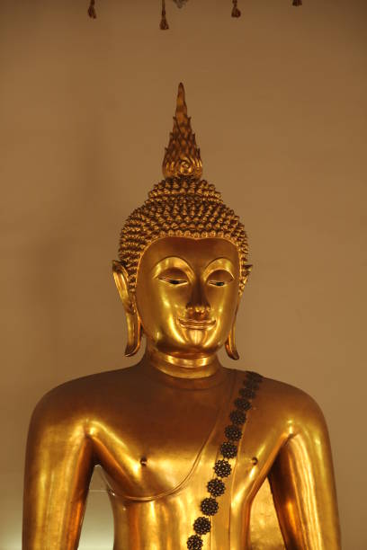 istock Golden Buddha statue in a serene setting with a neutral background in Bangkok, Thailand 2170303561