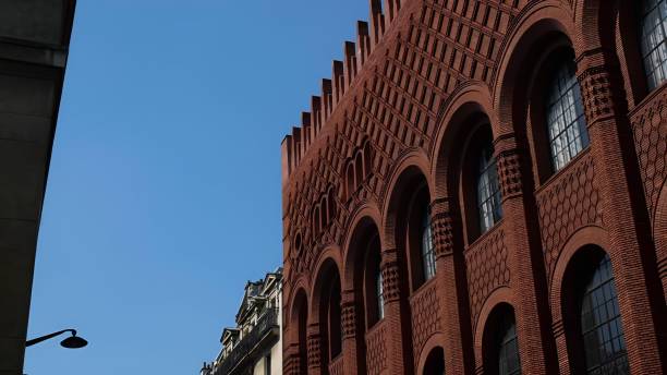 istock Historic red brick building with arched windows under clear blue sky 2170303765