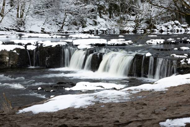 istock Winter Waterfall with Snow-Covered Surroundings 2170305012