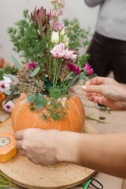 istock Creating a floral composition in a pumpkin. Making decor with your own hands. 2170305053