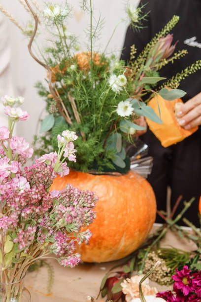 istock Creating a floral composition in a pumpkin. Making decor with your own hands. 2170305066