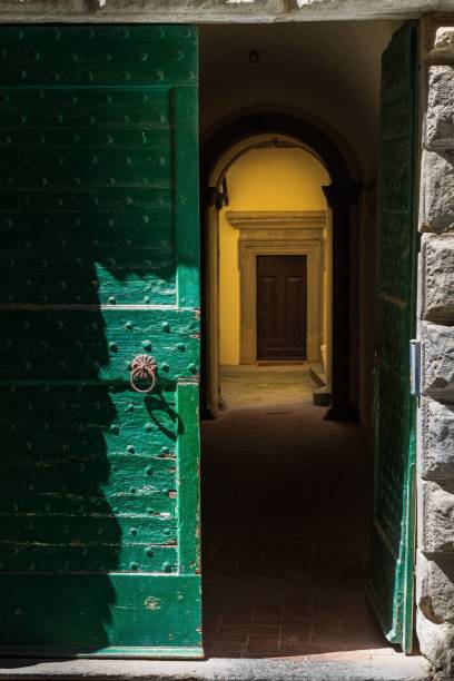 istock Partially open green door revealing a hallway inside a historic building. 2170305720