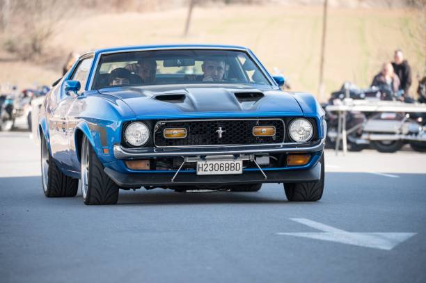 Navarcles, Spain – February 03, 2024: Front view of a nice classic blue facelifted first generation 1971 Ford Mustang Mach