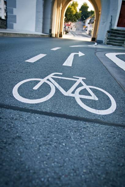 istock Bicycle lane symbol on a city road with archway. 2170307698