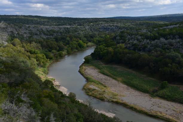 istock Scenic river view with lush green forests and hills. 2170308617