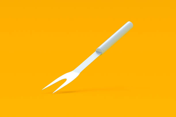 Falling carving fork on orange background. Barbecue Accessory. Cooking equipment. 3d render