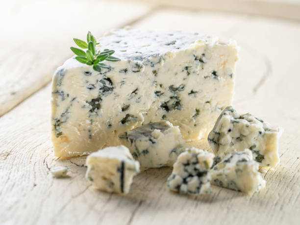 istock Blue cheese chunk with fresh thyme leaves on wooden table close up. 2170312655