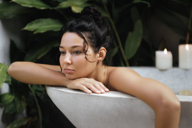 istock Contemplative Woman Relaxing in a Lush Tropical Bath 2170313686