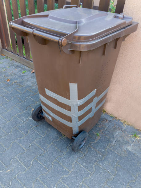 istock Damaged Brown Waste Bin with Amateur Repair 2170317774