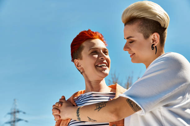 istock Joyful moments shared between a young lesbian couple under a sunny blue sky in a vibrant park 2170321462
