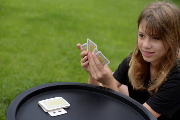 family playing cards outdoors. Board games
