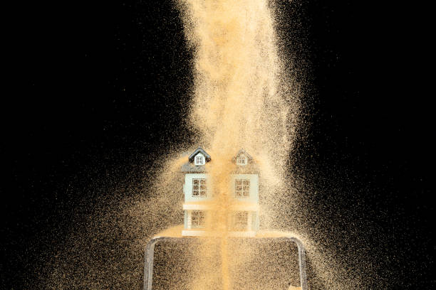 istock Sand storm hit House as natural disaster from climate change global warming. Strong wind of sand attack house with insurance create loss damage environment. Black background isolated 2170322977