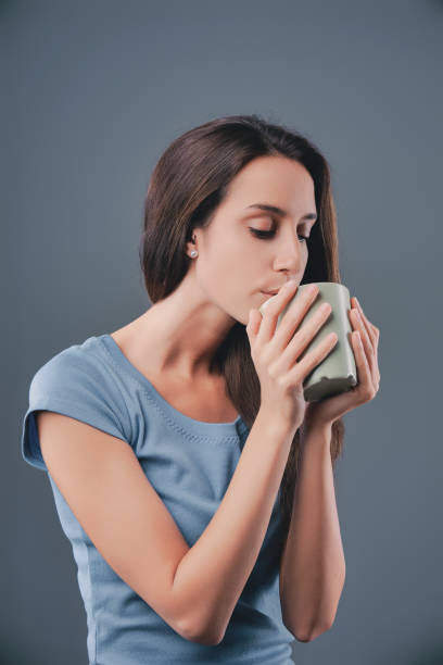 istock Young woman enjoying a moment of peace while drinking from her m 2170325610