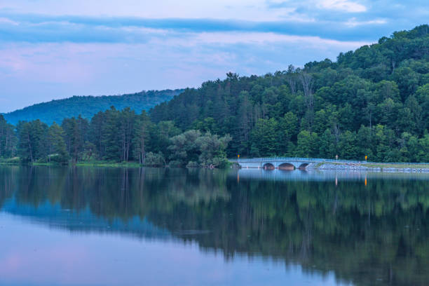 istock Setting sun low light long exposure over mountain lake summer season background image 2170329333