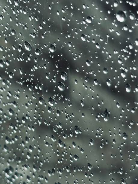 istock Close-Up of Rain Drops on Transparent Glass Surface 2170331926