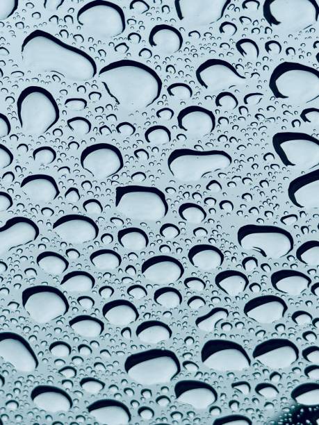 istock Close-Up of Rain Drops on Transparent Glass Surface 2170331940