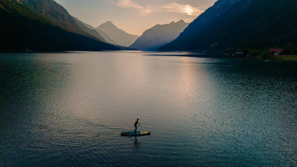 istock Exploring the serene waters of Plansee, Austria at sunset on a paddleboard 2170334198