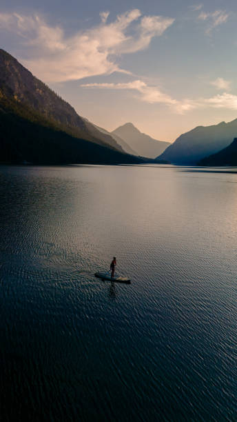 istock Serene paddle boarding experience at sunset on Lake Plansee in Austria's stunning alpine landscape 2170338423