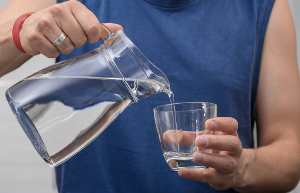 istock Man holding a jug of water, drinking water during training 2170338579