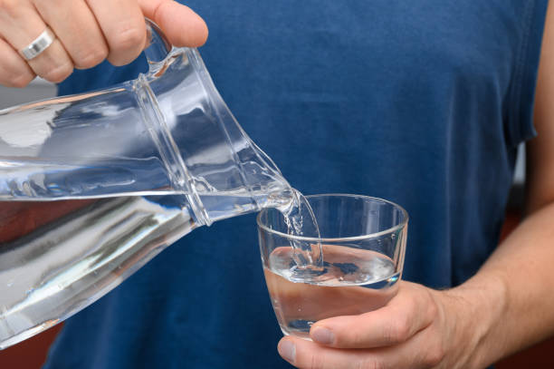 istock A glass being filled with water from a jug 2170338601