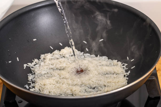 istock Close-up of rice cooked in a pan, poured with boiling water 2170338731