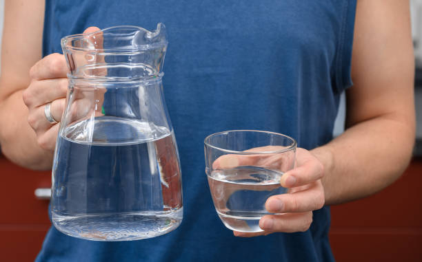 istock A young man replenishes his fluids on hot days with fresh tap water. 2170338737