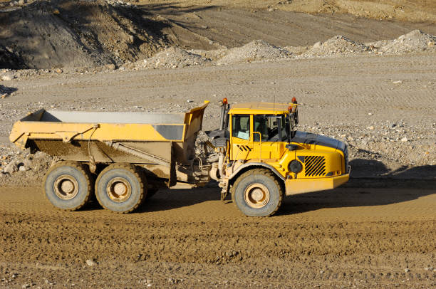 istock Yellow dump truck working in gravel pit 2170339456