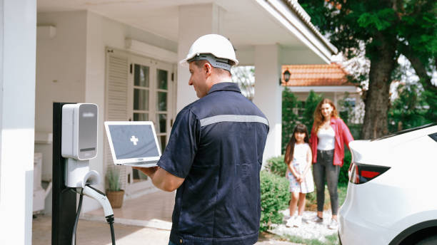 istock Qualified technician working with laptop for home EV station. Synchronos 2170340406