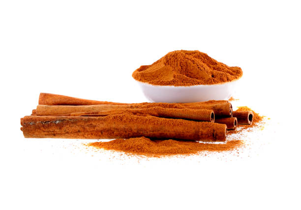 Cinnamon sticks and Cinnamon powder in white  bowl on white background