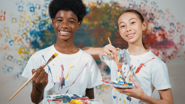 Student with mixed races smile and look at camera at art lesson. Edification.