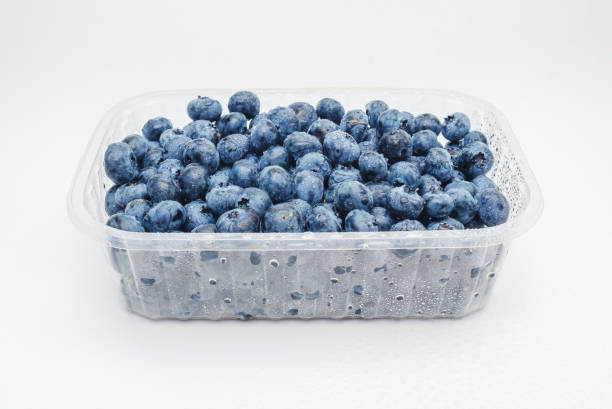 Transparent box with fresh blueberries isolated on white. Side view. Antioxidants, vitamins, health.