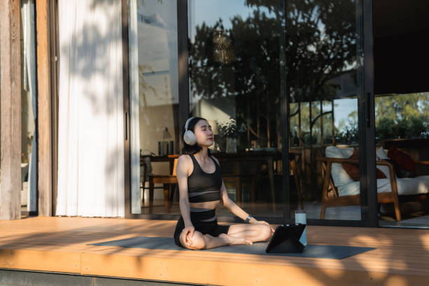 istock Asian woman doing yoga at home 2170345162