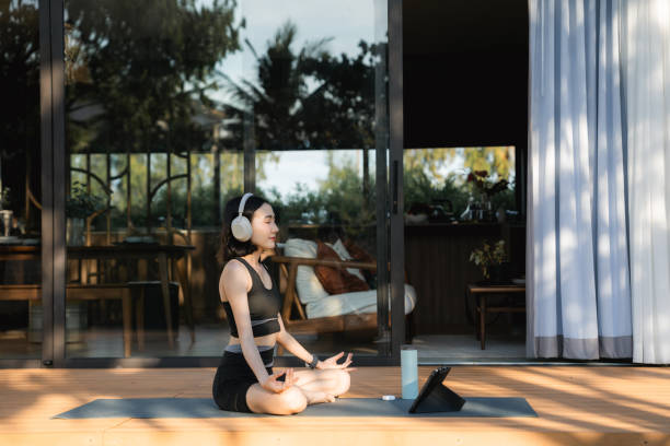 istock Asian woman doing mindful meditation at home 2170346016