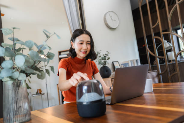 istock Asian woman using AI virtual assistant speaker at home 2170346276