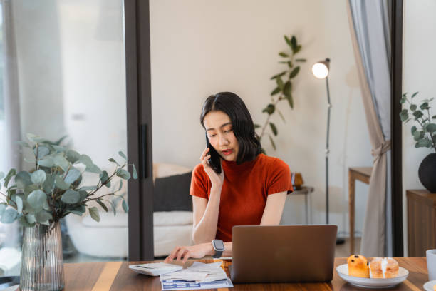 istock Young woman Paying Bills Online at home 2170346368