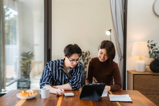 istock Asian couple doing finances at home 2170346398