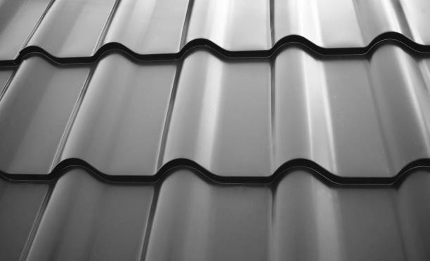 istock Close-up view lightweight steel roofing sheet. Black color coated modular tile effect roof panel. Traditional metal shingle tiles. Popular profiled metallic pantile mimic clay or concrete slate 2170346770