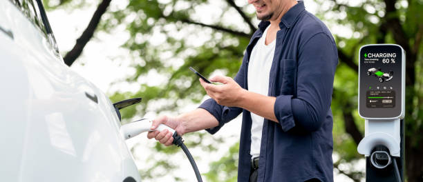 istock Man using smartphone to pay for electric car charging. Exalt 2170348187