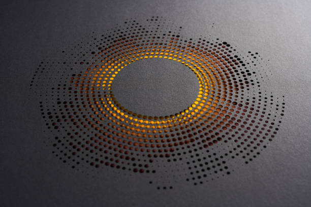 istock Abstract circular paper cut design with dispersed dot pattern and glowing orange backlighting 2170348636