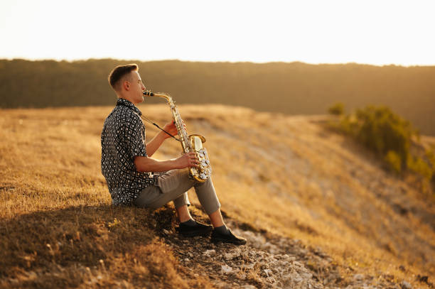 istock A talented saxophonist skillfully plays soothing melodies while a gorgeous sunset creates a stunning backdrop 2170351357